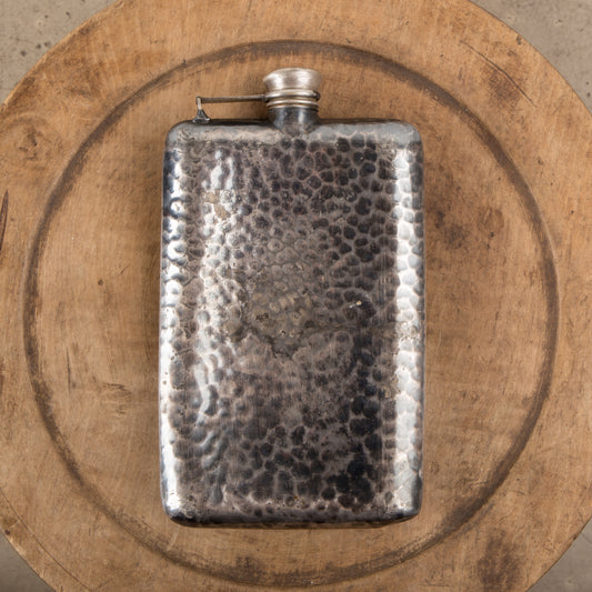 A hammered tin flask