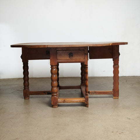 A Danish 18th century Baroque pine drop leaf table